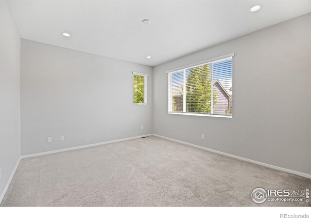 4672 Clear Creek Dr, Longmont, CO 80504 - empty room with healthy amount of natural light, carpet floors, baseboards, and recessed lighting
