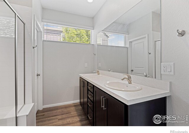 4672 Clear Creek Dr, Longmont, CO 80504 - full bath featuring wood finished floors, plenty of natural light, double vanity, and tiled shower