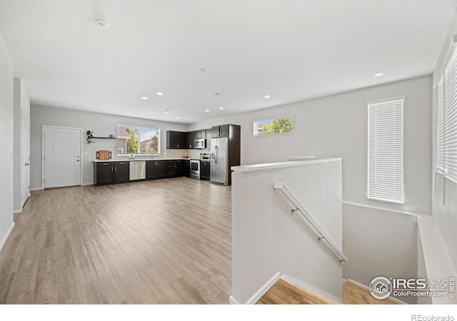 4672 Clear Creek Dr, Longmont, CO 80504 - unfurnished living room with healthy amount of natural light, light wood-type flooring, recessed lighting, and baseboards