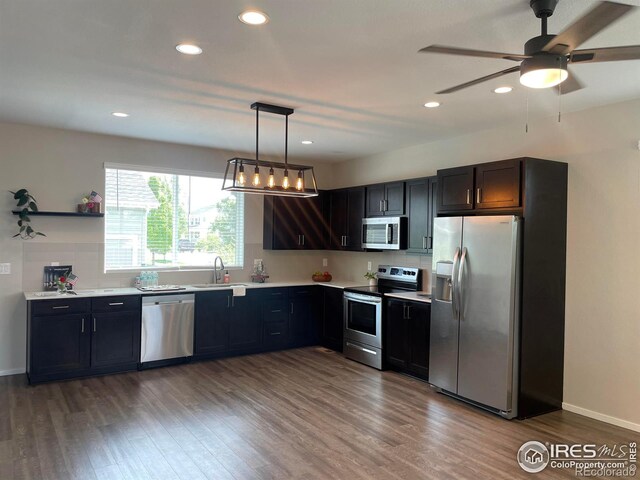 4672 Clear Creek Dr, Longmont, CO 80504 - kitchen featuring stainless steel appliances, a sink, wood finished floors, a ceiling fan, and recessed lighting