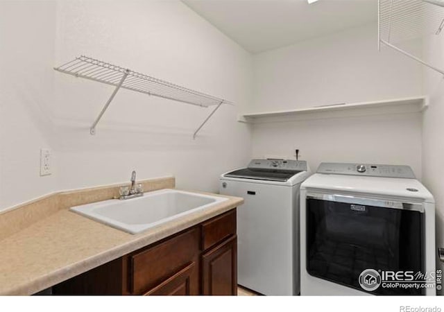 6117 Gold Dust Rd, Timnath, CO 80547 - laundry room with washer and clothes dryer and cabinet space