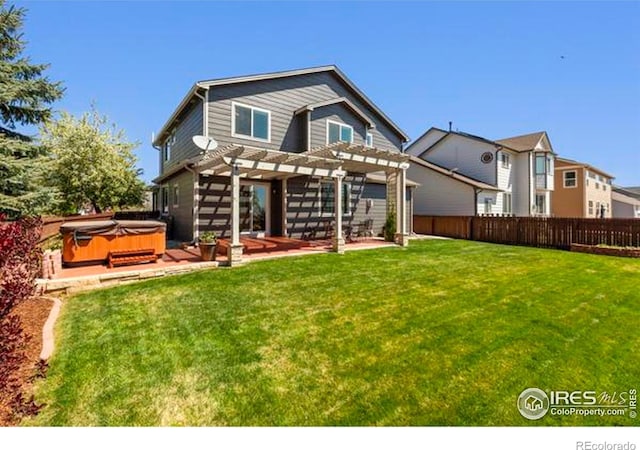 6117 Gold Dust Rd, Timnath, CO 80547 - back of property with a hot tub, a pergola, and a patio
