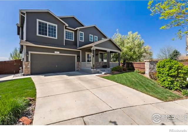 6117 Gold Dust Rd, Timnath, CO 80547 - craftsman house with covered porch, an attached garage, concrete driveway, and stone siding