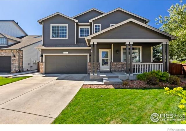 6117 Gold Dust Rd, Timnath, CO 80547 - craftsman-style home featuring a porch, concrete driveway, a garage, a front yard, and stone siding