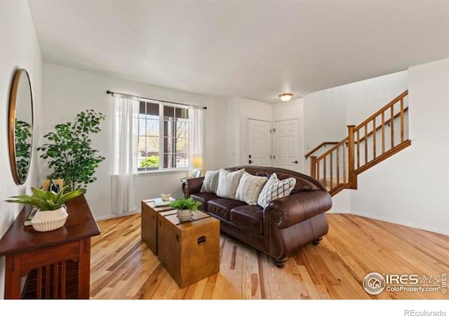 6117 Gold Dust Rd, Timnath, CO 80547 - living area with light wood-type flooring and stairs