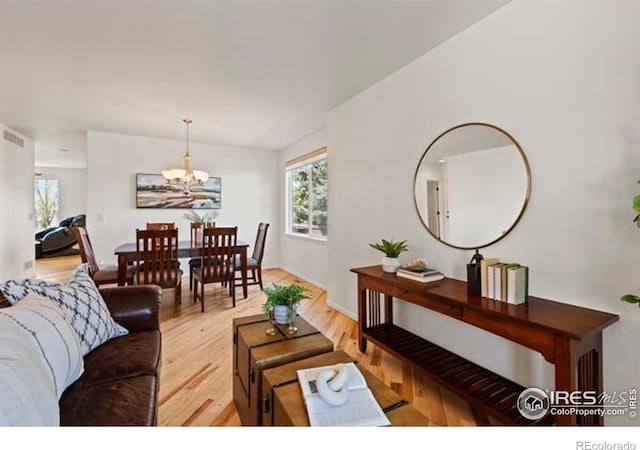 6117 Gold Dust Rd, Timnath, CO 80547 - living area featuring light wood-style floors and a chandelier