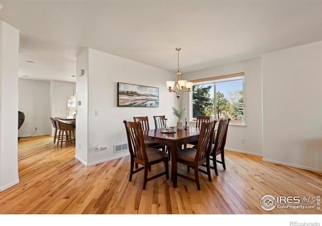 6117 Gold Dust Rd, Timnath, CO 80547 - dining room featuring light wood-type flooring and a chandelier