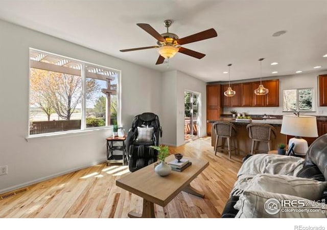 6117 Gold Dust Rd, Timnath, CO 80547 - living room with plenty of natural light, a ceiling fan, light wood-style floors, and recessed lighting