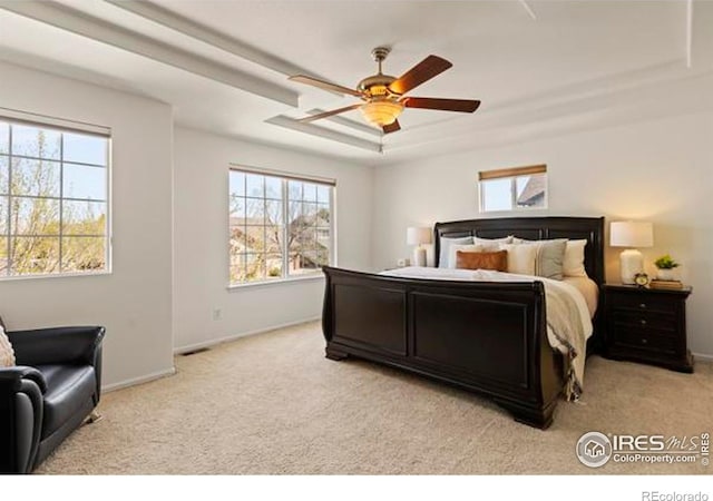 6117 Gold Dust Rd, Timnath, CO 80547 - bedroom with light carpet, a raised ceiling, and a ceiling fan