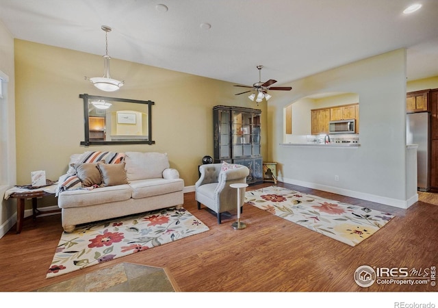 5775 29th St Unit 101, Greeley, CO 80634 - living area featuring a ceiling fan, baseboards, and wood finished floors