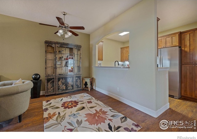 5775 29th St Unit 101, Greeley, CO 80634 - interior space featuring baseboards, a ceiling fan, arched walkways, and wood finished floors