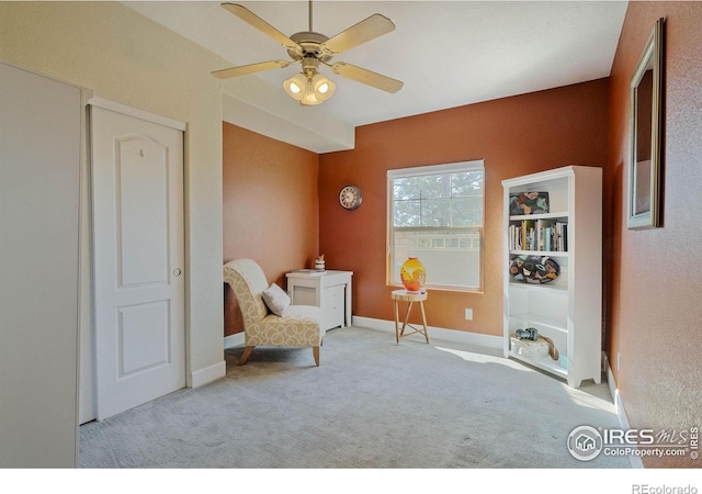 5775 29th St Unit 101, Greeley, CO 80634 - sitting room featuring baseboards, a ceiling fan, and carpet flooring