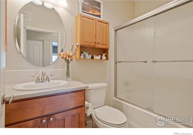 5775 29th St Unit 101, Greeley, CO 80634 - full bath featuring toilet, bath / shower combo with glass door, and vanity