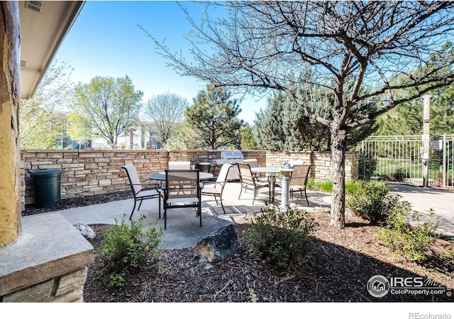 5775 29th St Unit 101, Greeley, CO 80634 - view of patio / terrace with a fenced backyard and outdoor dining space