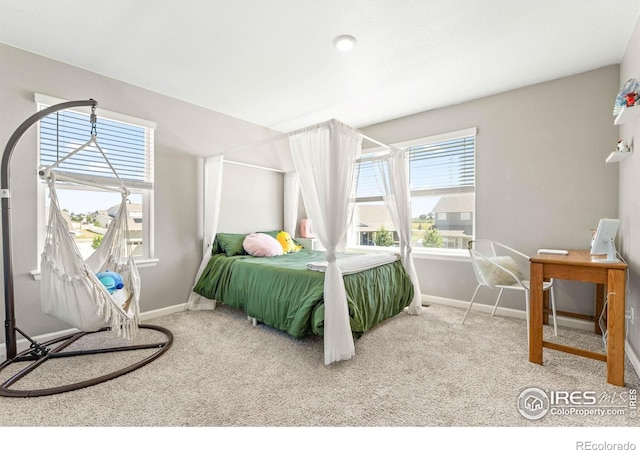 carpeted bedroom featuring baseboards