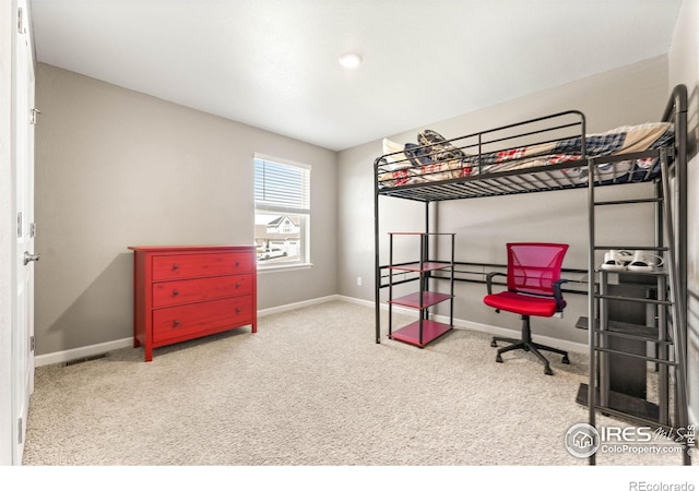 carpeted bedroom featuring baseboards and visible vents
