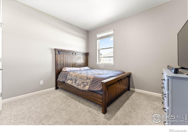 bedroom featuring carpet floors and baseboards