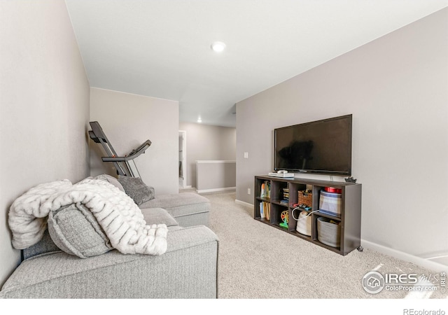 carpeted living area with recessed lighting and baseboards