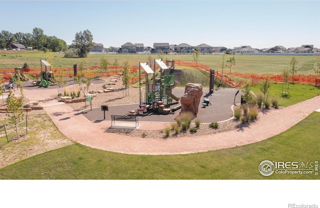 communal playground featuring a residential view and a yard