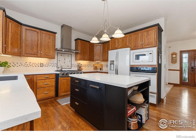 kitchen featuring white appliances, light countertops, open shelves, and wall chimney exhaust hood