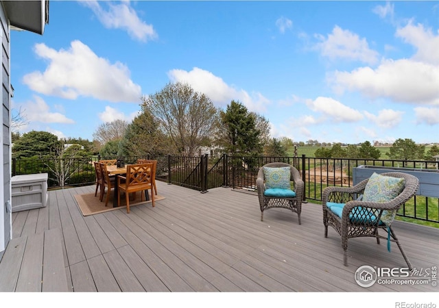 wooden terrace featuring outdoor dining area