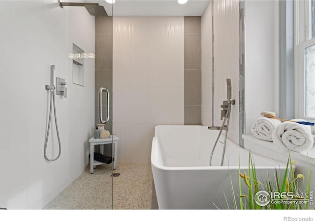 full bathroom featuring a soaking tub and a walk in shower