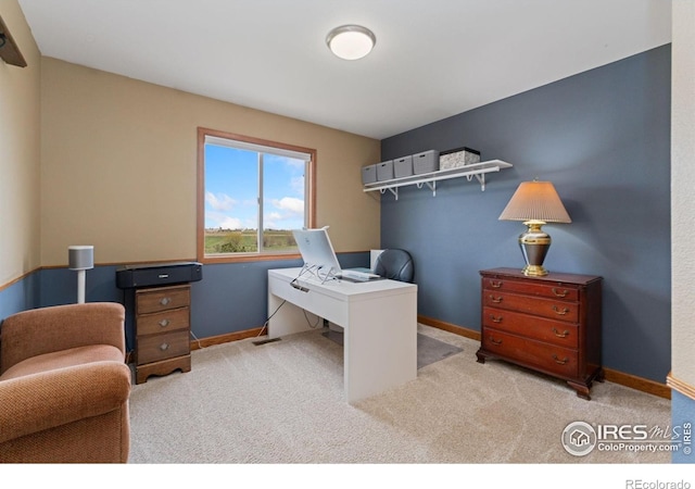 carpeted office featuring visible vents and baseboards