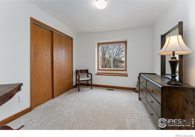 sitting room with light carpet, baseboards, and visible vents