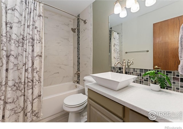 bathroom featuring toilet, vanity, shower / bath combo with shower curtain, and tasteful backsplash