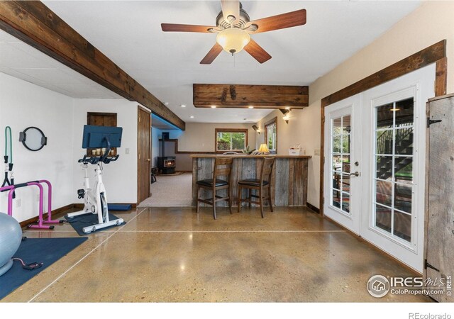 interior space with beam ceiling, recessed lighting, a ceiling fan, speckled floor, and baseboards
