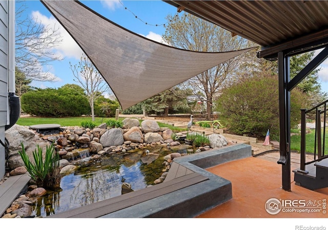 view of patio / terrace featuring a small pond