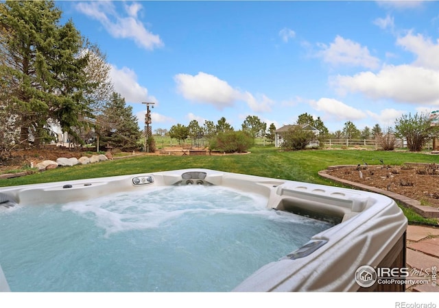 view of patio with a hot tub and fence