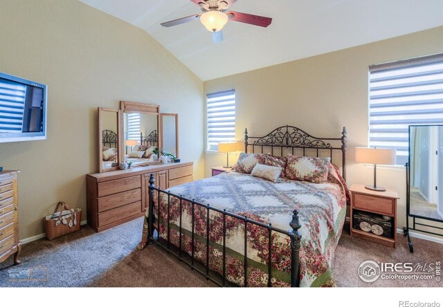 bedroom featuring baseboards, vaulted ceiling, ceiling fan, and carpet