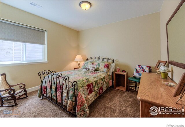 bedroom featuring carpet floors, baseboards, and visible vents