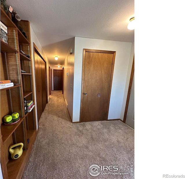 910 H Ave, Limon, CO 80828 - hallway featuring a textured ceiling and carpet