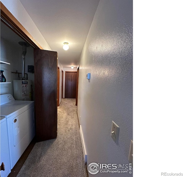 910 H Ave, Limon, CO 80828 - hallway featuring a textured wall, baseboards, washing machine and clothes dryer, carpet flooring, and water heater