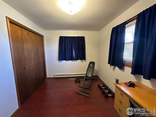 910 H Ave, Limon, CO 80828 - exercise area featuring baseboards, a baseboard radiator, and wood finished floors