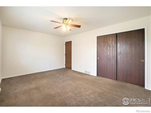 unfurnished bedroom with carpet floors, a ceiling fan, a closet, and visible vents