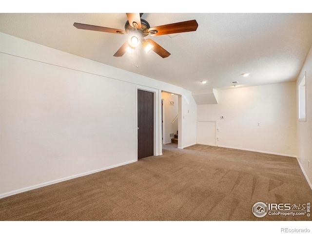 empty room with baseboards, a ceiling fan, and carpet