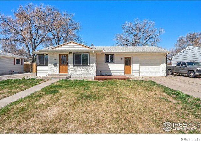 113 Balsam St, Fort Morgan, CO 80701 - view of front of home featuring driveway, a front yard, fence, an attached garage, and stone siding