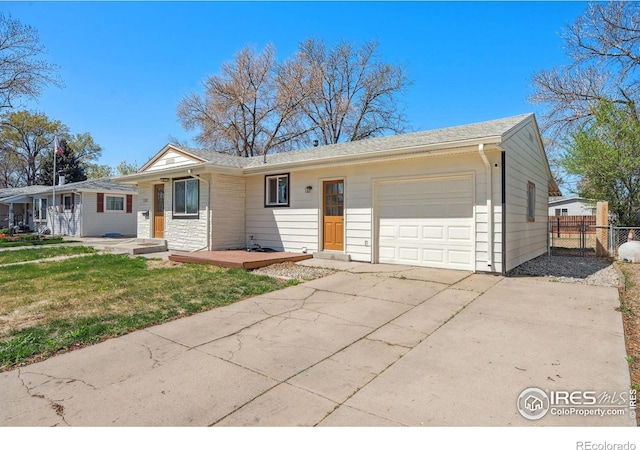 113 Balsam St, Fort Morgan, CO 80701 - ranch-style house featuring a garage, fence, a front yard, and concrete driveway