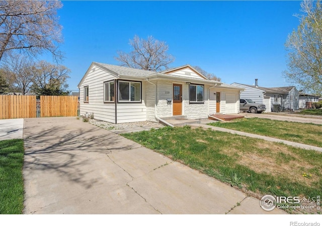113 Balsam St, Fort Morgan, CO 80701 - bungalow-style house with fence, driveway, and a front yard