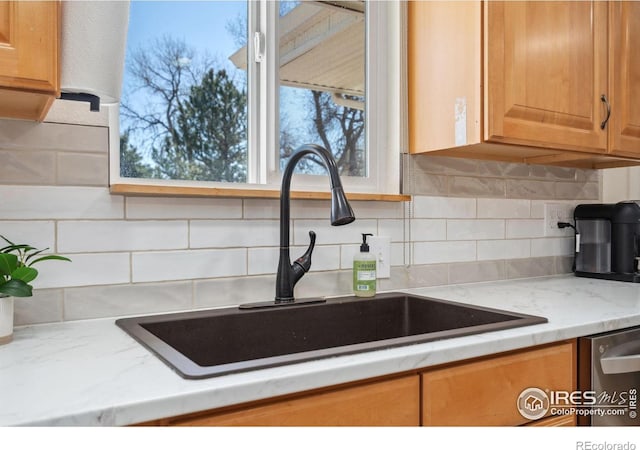 113 Balsam St, Fort Morgan, CO 80701 - kitchen featuring a sink, decorative backsplash, dishwasher, and light stone countertops