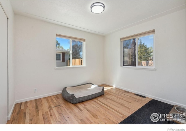 113 Balsam St, Fort Morgan, CO 80701 - bedroom featuring baseboards, visible vents, and wood finished floors