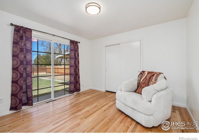 113 Balsam St, Fort Morgan, CO 80701 - living area with baseboards, wood finished floors, and visible vents