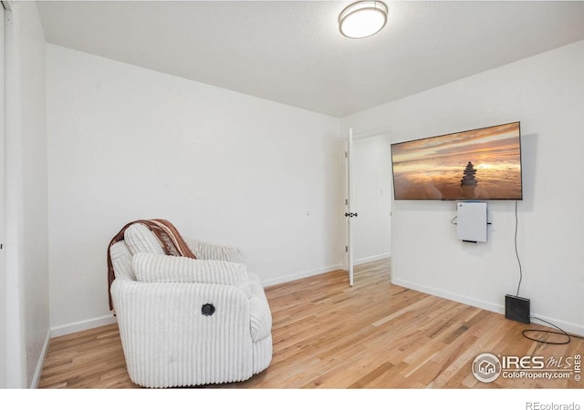 113 Balsam St, Fort Morgan, CO 80701 - sitting room featuring baseboards and wood finished floors