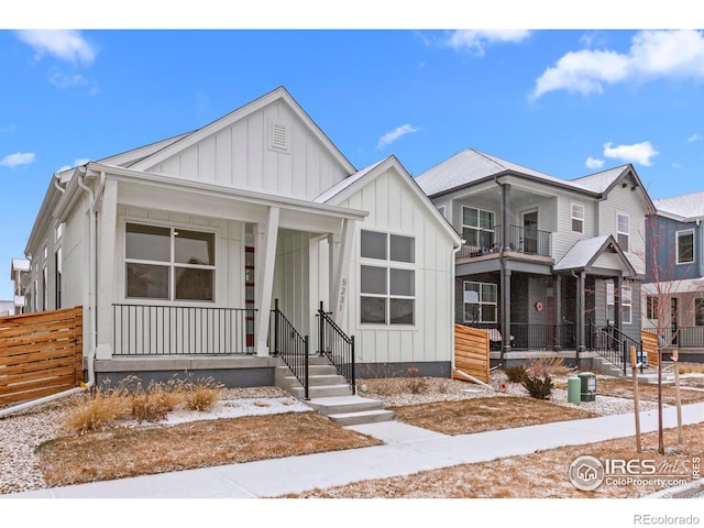 view of front of home with board and batten siding, a balcony, and a porch