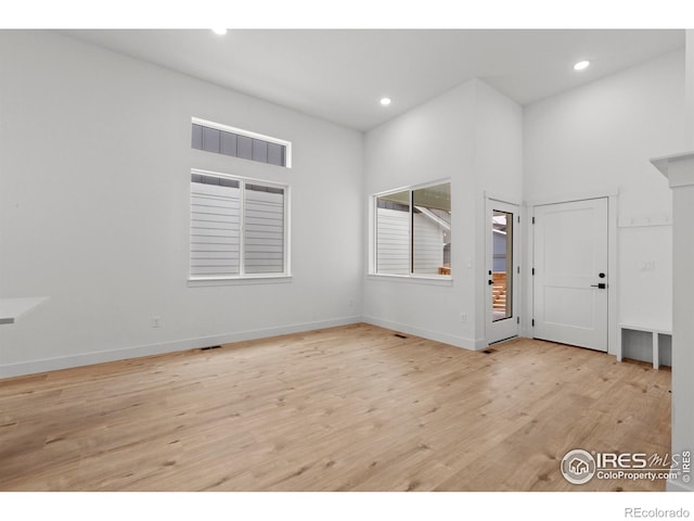 interior space with recessed lighting, light wood-style flooring, and baseboards