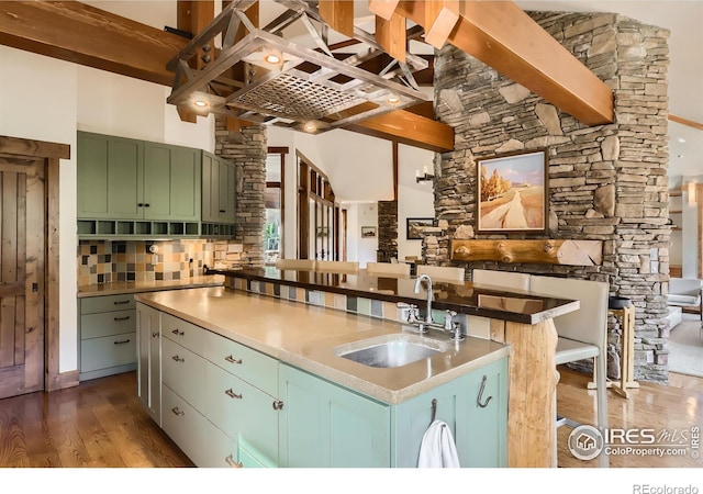 2307 Magnolia Dr, Nederland, CO 80466 - kitchen with tasteful backsplash, a sink, beamed ceiling, green cabinets, and dark wood-type flooring