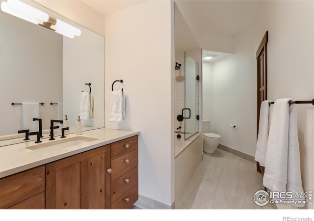 2307 Magnolia Dr, Nederland, CO 80466 - bathroom with baseboards, enclosed tub / shower combo, toilet, and vanity